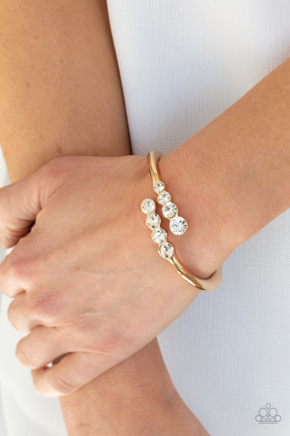 Paparazzi Accessories-Defying Dazzle Gold Glittery Rhinestone Bracelet